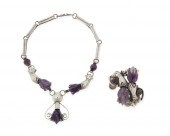 A SILVER PENDANT NECKLACE AND