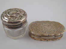A silver pill box with engraved