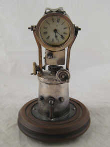 A silver plated clock designed as a