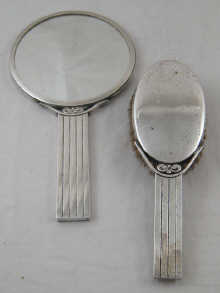 A silver plated mirror and brush of