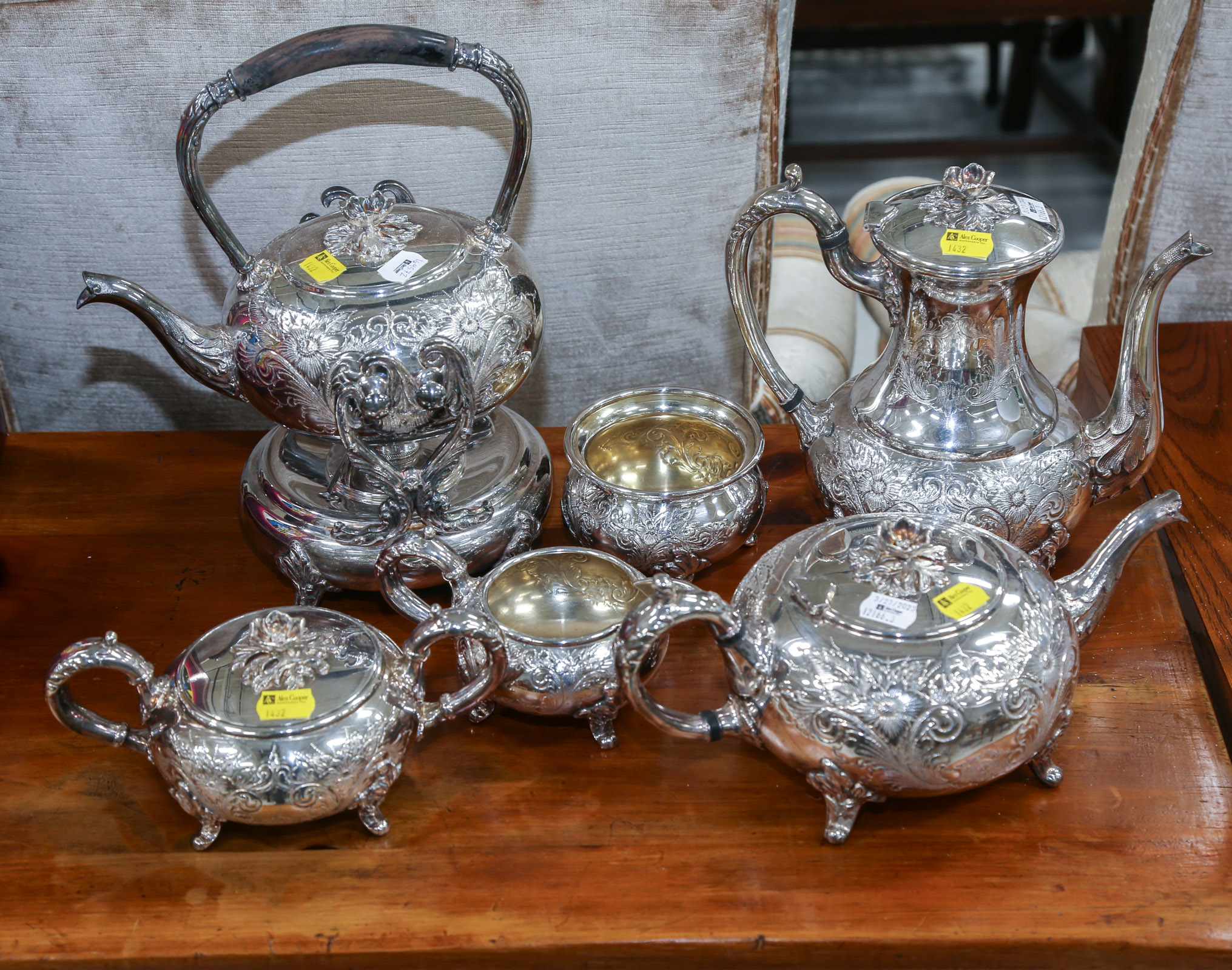 A SILVER-PLATED PARTIAL TEA &
