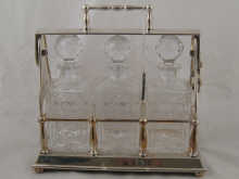 A silver plated three bottle