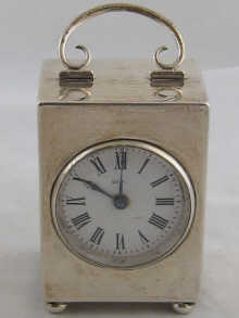 A silver rectangular clock on