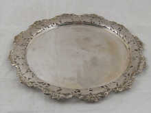 A silver salver with pierced border