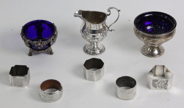 A silver sugar basin with blue