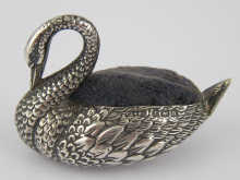 A silver swan pin cushion