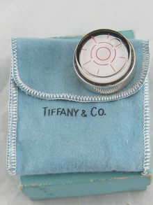 A silver Tiffany liquid compass