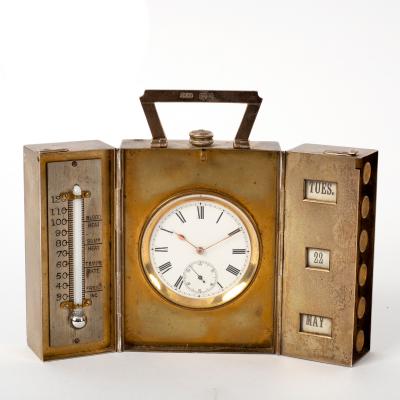 A silver travelling clock, H.S.B.