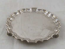 A silver waiter with chippendale