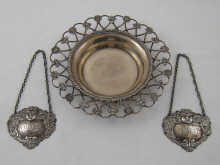 A silver wine coaster the rim