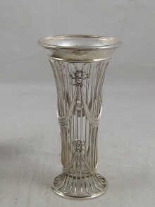A silver wirework vase with glass