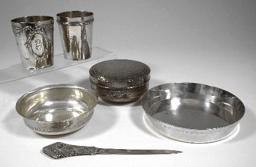 A silvery metal tumbler with raised
