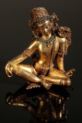 A SINO-TIBETAN GILT BRONZE FIG