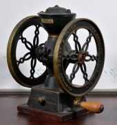 A small antique iron coffee mi