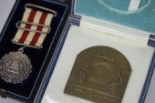 A small bronze plaque by Spink