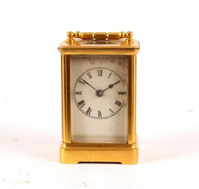 A small carriage clock in a gilt