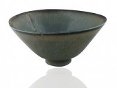 A SMALL TRIANGULAR GLAZED STON
