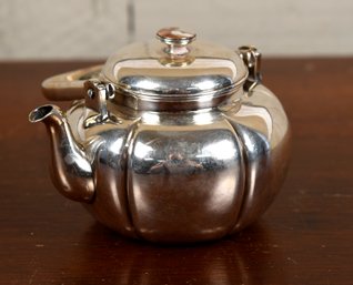 A small vintage teapot with Chinese