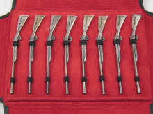 A soft leather pouched set of eight