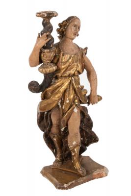 A Spanish carved figural candle