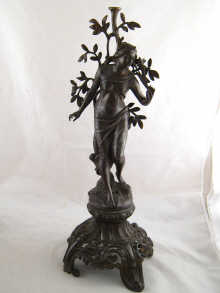 A spelter figure of a woman on an