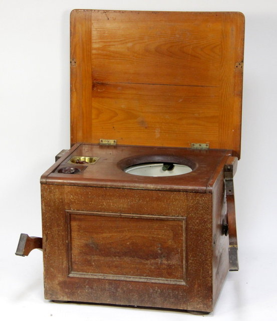 A stained pine commode the hinged