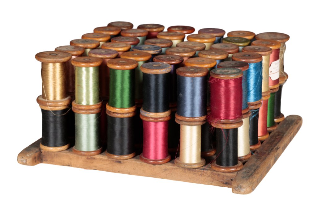 A STAINED WOOD SPOOL RACK with iron