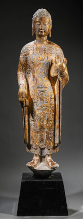 A STONE CARVED AND GILT SHAKYA