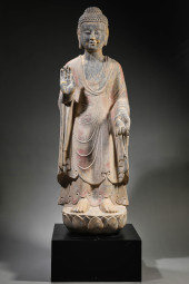 A STONE CARVED STANDING FIGURE