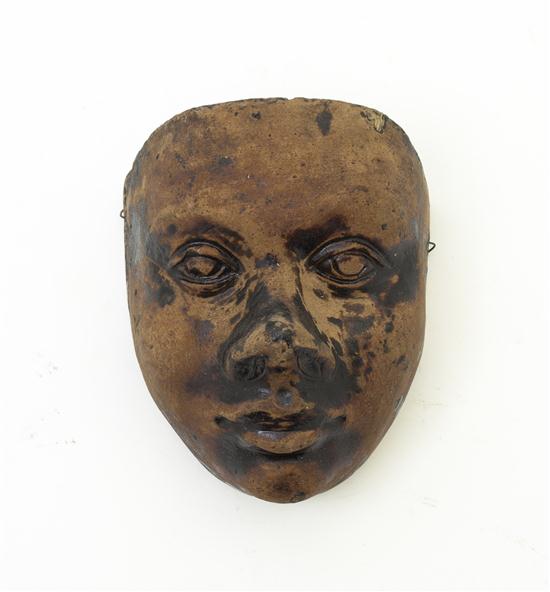 * A Stoneware Mask having