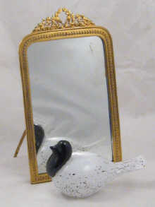 A strut back table mirror with gilt
