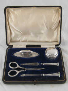 A stylish five piece silver mounted