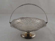A swing handled pierced silver cake