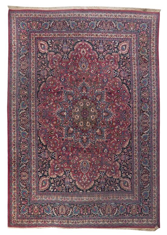 A Tabriz Wool Rug centered with a