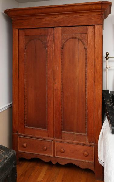 A TALL 19TH C. TWO DOOR WARDROBE