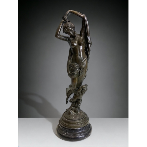 A TALL BRONZE SCULPTURE DEPICTING