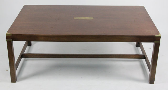 A teak coffee table with brass