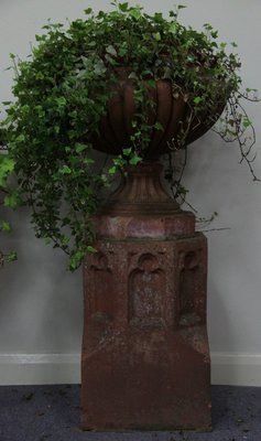 A terracotta lobbed urn on a Gothic