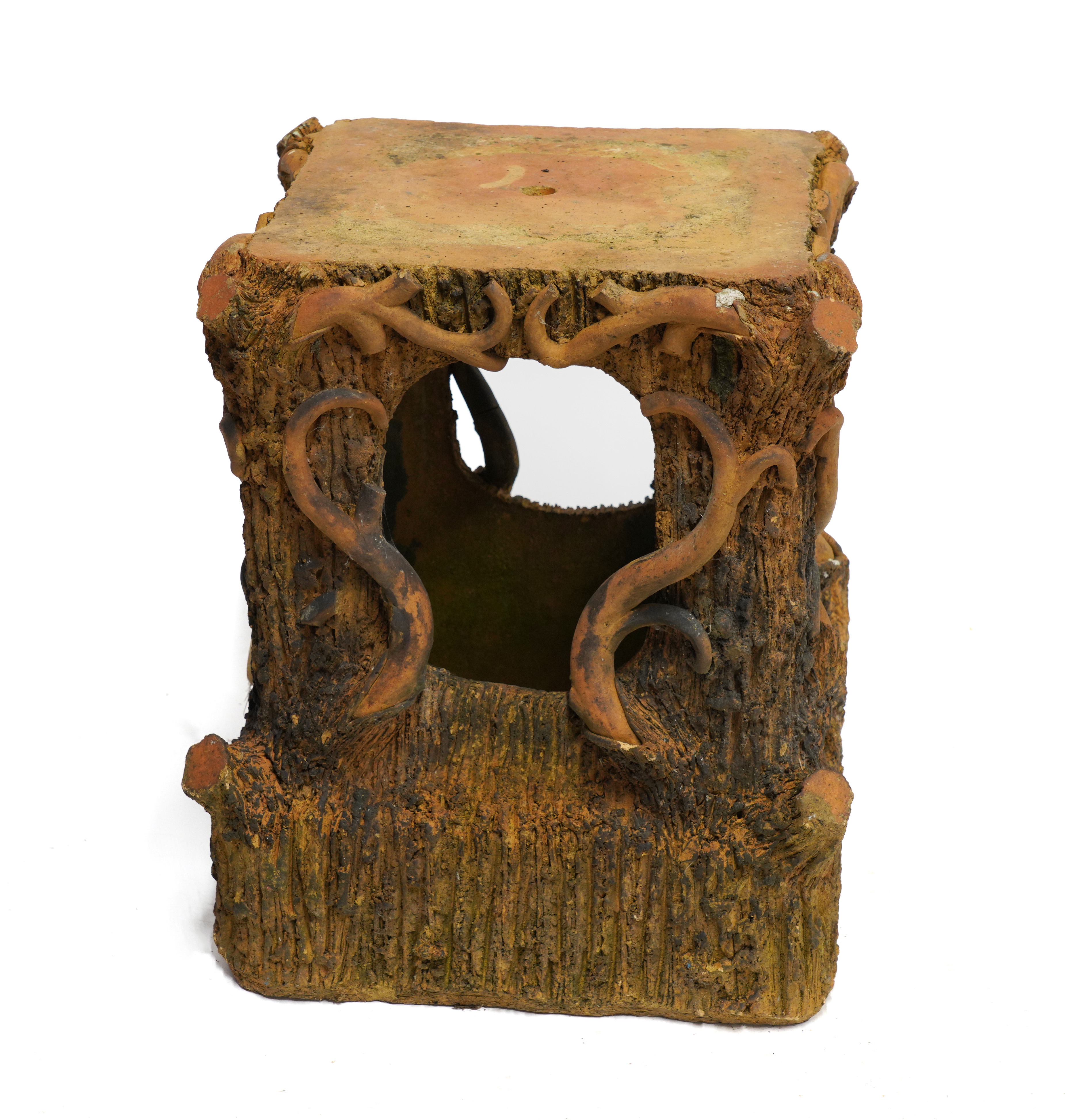 A TERRACOTTA PLINTH OF NATURALISTIC