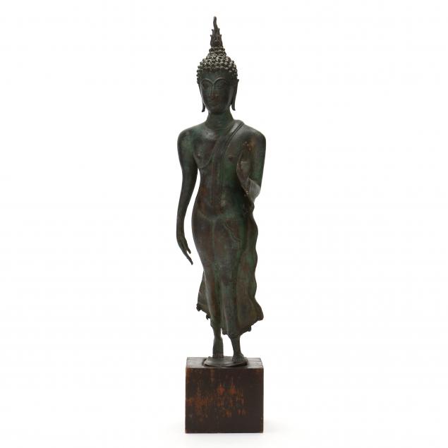 A THAI BRONZE WALKING BUDDHA