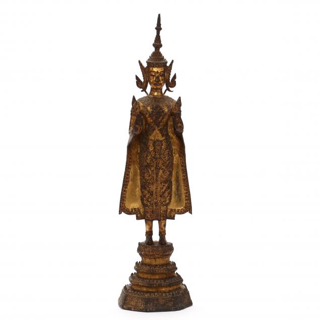 A THAI GILT BRONZE STANDING BUDDHA