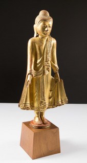 A THAI GILT-WOOD STANDING BUDD