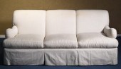 A three cushion sofa with tigh