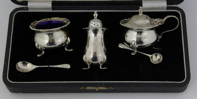 A three-piece silver cruet set