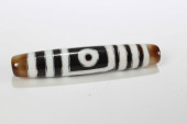 A TIBETAN RELIGIOUS DZI BEAD<b