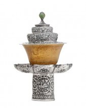 A TIBETAN SILVER COVERED STAND