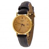 A TISSOT WRIST WATCH IN 18K 18