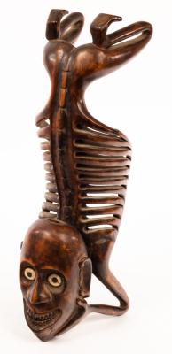 A tribal carving of a kneeling