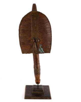 A tribal mask on stand of