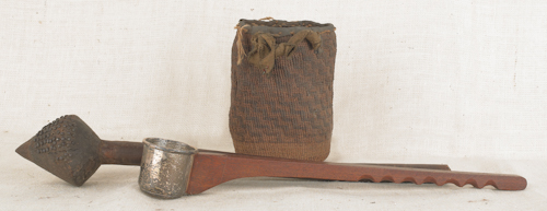 A tribal war club with brass